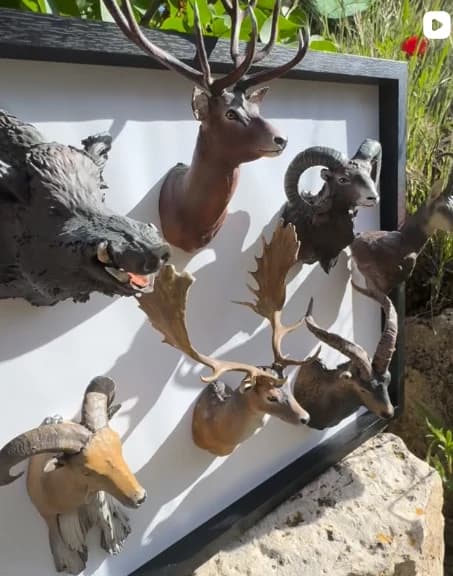 Instagram post: frame with miniature hunting trophies